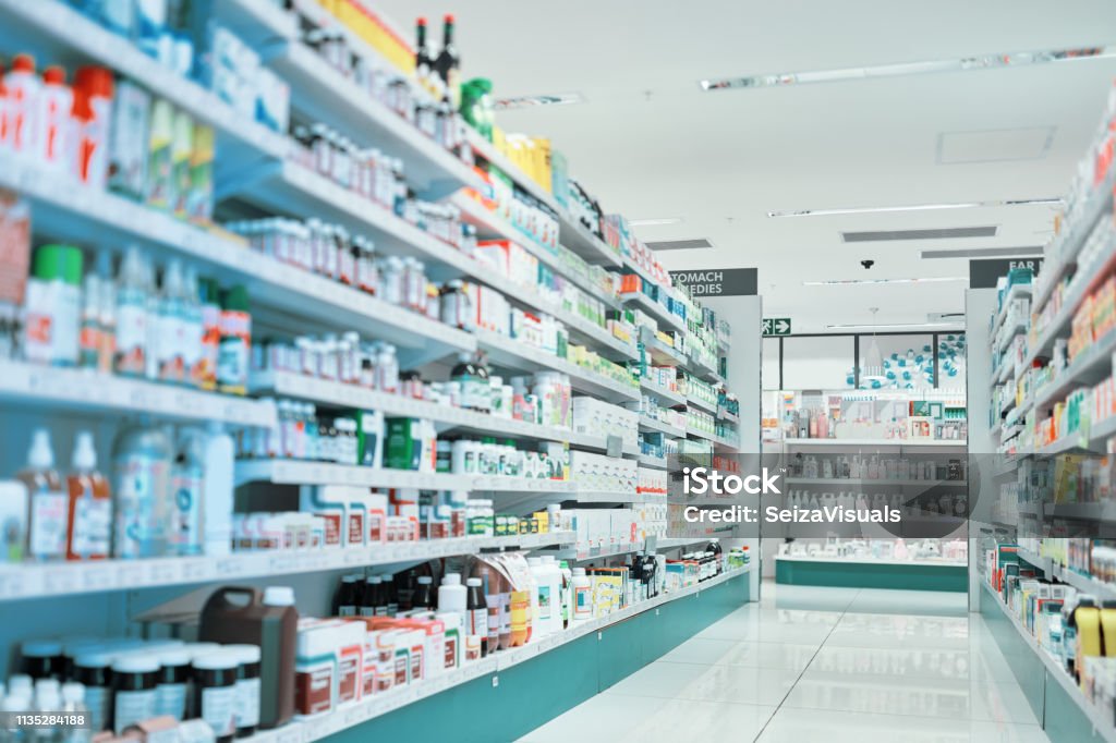 cropped shot of fully stocked shelves in an aisle of a pharmacy